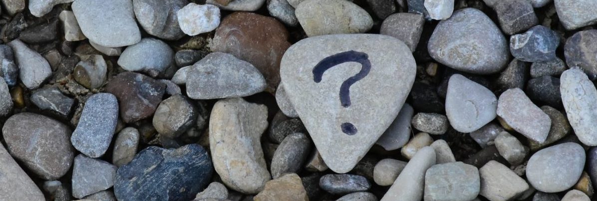 Rocks with a question mark drawn on